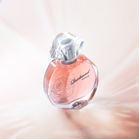 Perfume para Mujer en Botella Redonda de Vidrio Color Durazno, Tapa Transparente Facetada, Brillo Teal, Doble Radiante, Encantador y Persistente