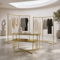 Comptoir de présentation en métal doré avec base en X pour magasin de vêtements, fourniture d'usine OEM ODM
