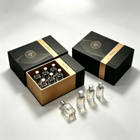 Boîte cadeau de luxe pour parfum, en carton rigide noir et or, avec tiroir coulissant personnalisé et insert en mousse pour l'emballage de parfum.