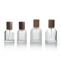 Fabricante de botellas de perfume vacías 30ml 50ml 100mL Cilindro de fragancia Botellas de vidrio redondas con tapa de madera