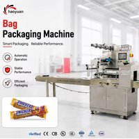 Machine d'emballage professionnelle à performance stable avec contrôle PLC pour l'emballage de bonbons, biscuits, pain et autres produits alimentaires en sachets de type oreiller