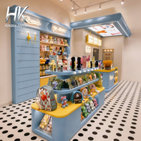 Comptoir d'exposition incurvé lumineux à LED, personnalisable (bleu/jaune), éco-responsable, avec dessus en bois et étagères pour magasin de jouets pour enfants