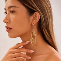 Boucles d'oreilles en fil de fer style européen et américain, en zircon métallique, ovales, ajourées, en forme de croix, pour femme, tendance, uniques, mode de niche