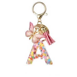Porte-clés personnalisé avec nom, en résine rose, breloque initiale scintillante en résine à 26 lettres avec pompon papillon, accessoire décoratif pour sacs - Product Image 4