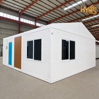 Maison conteneur moderne personnalisée à 2 chambres, pliable et extensible, avec structure en acier blanc, porte coulissante en verre isolant, cuisine intégrée pour ADU de jardin