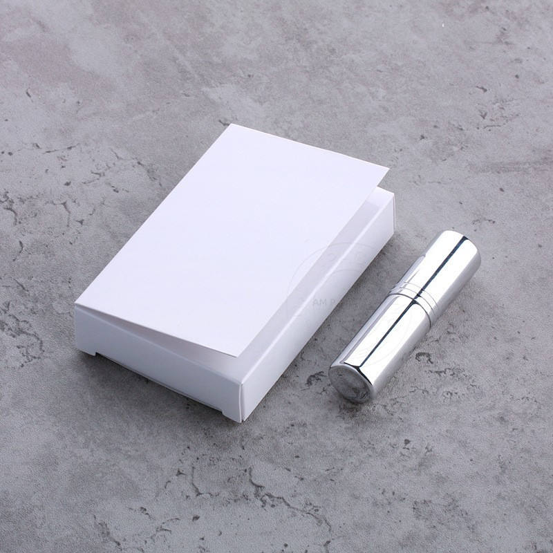 Silver perfume spray bottle with white box