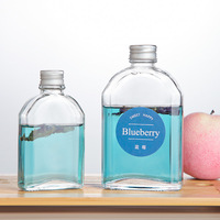 Vente en gros Flacon plat transparent à épaulement en ardoise Récipient en verre pour boissons Jus de fruits Vin Café Bouteille de thé avec couvercles