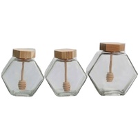 Tarro de miel único con cuchara de madera, tarro de vidrio hexagonal al por mayor para miel