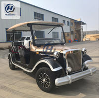 Voiturette de golf électrique noire et champagne au style vintage pour le transport dans les complexes hôteliers et l'hôtellerie