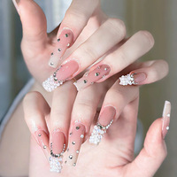 Ongles à presser artisanaux de luxe, effet ombré nude-blanc, forme cercueil, avec grappes de perles placées à la main et strass de différentes tailles dispersés