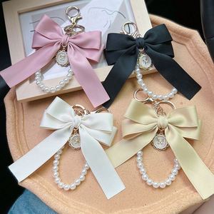 Porte-clés élégant avec nœud et perles pour femme, breloque de sac, support de clés de voiture avec pendentif, porte-clés féminin en soie - Product Image 5
