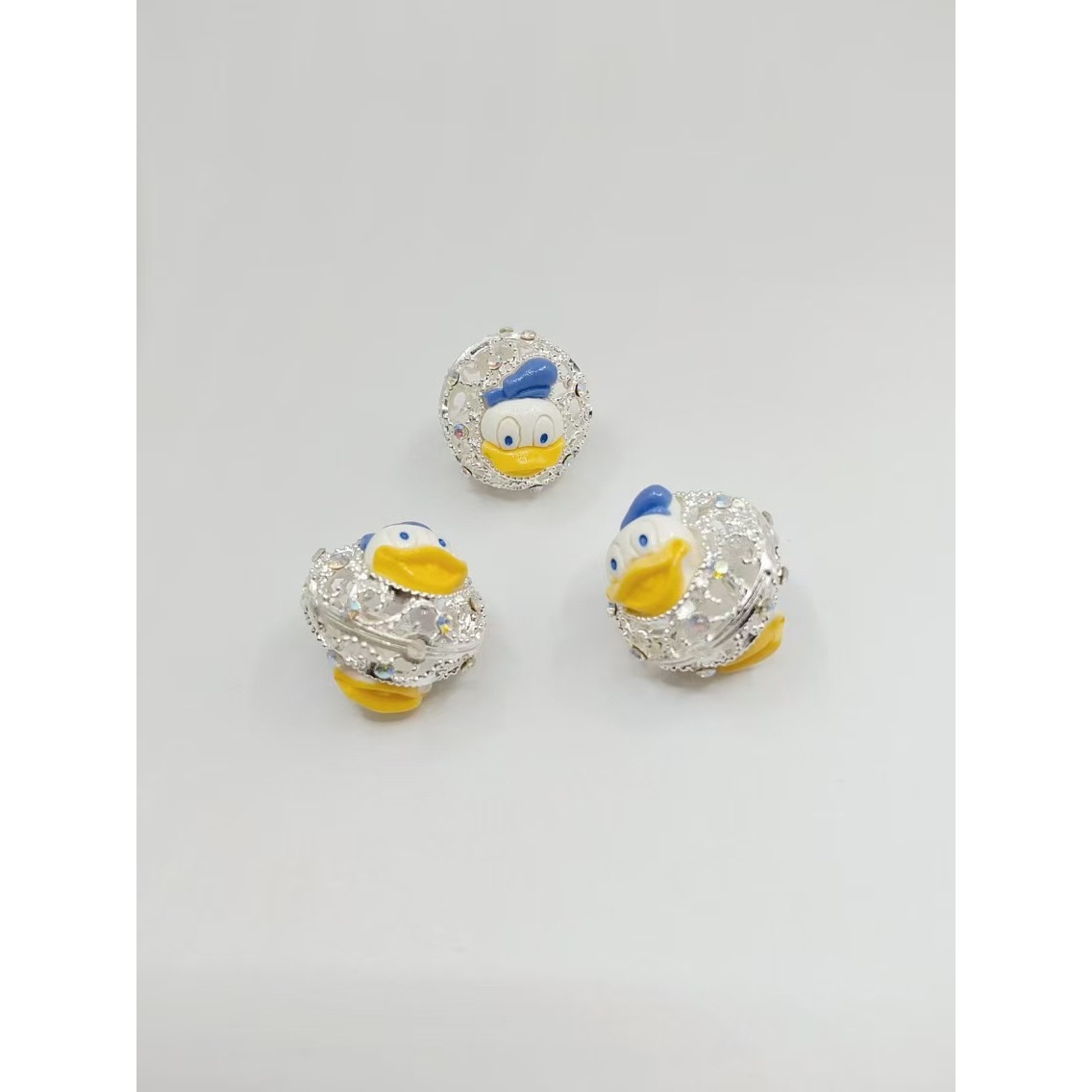Round, silver-plated Donald Duck