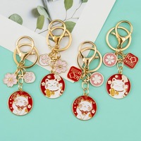 Vente en gros de breloques en fleurs de cerisier japonaises, chat mignon, couple créatif, accessoires de sac, porte-clés en métal pour cadeau