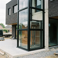 Ascensore Residenziale Panoramico in Vetro per Esterni con Vano in Alluminio Nero per Case Moderne in Mattoni - Design Elevatore Domestico