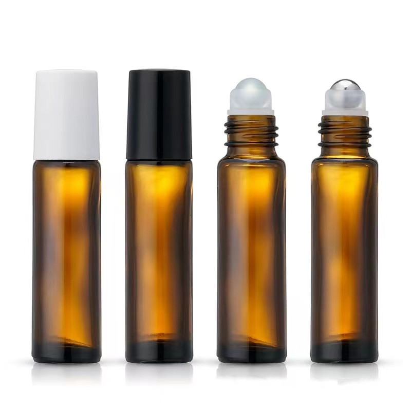 ขวดสีเหลืองอำพันพร้อมลูกบอลเหล็กพร้อมฝาสีดำ