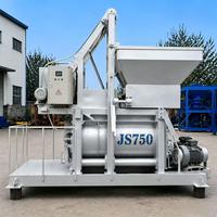 JS750 Double Shaft Forced Mixer dengan Motor Abu-abu, Motor Penggerak Hijau Tua, Tutup Ujung Kuning, dan Kabel Pengangkat.