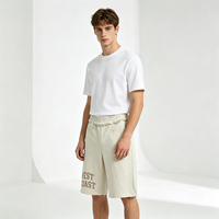 Pantalon court décontracté ivoire à ourlet effiloché, broderie chenille lettres, taille à volants, style streetwear