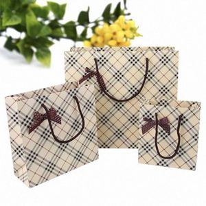Bolsa de Papel Elegante Color Piel con Diseño a Cuadros, Lazo Marrón Premium, Fondo Crema, Estilo Sofisticado con Patrón de Rejilla - Product Image 1