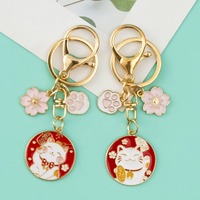 Vente en gros de breloques en fleurs de cerisier japonaises, chat mignon, couple créatif, accessoires de sac, porte-clés en métal pour cadeau
