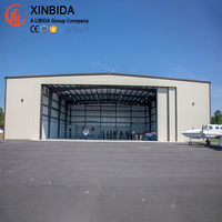 Hangar d'avion préfabriqué en acier haute résistance, grande portée, anti-vent et anti-neige, ouverture personnalisée, construction rapide sur site