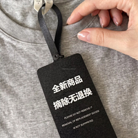 Étiquettes de vêtements noires personnalisées inviolables avec sceau de sécurité à usage unique, impression sérigraphique blanche sur tissu scintillant pour marques de vêtements