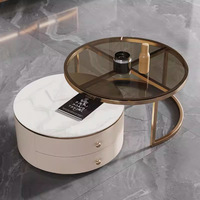 Table basse relevable moderne en pierre frittée avec rangement dissimulé, beige crème, structure métallique minimaliste, mobilier de salon