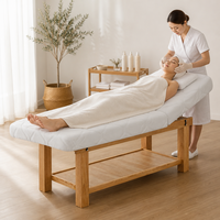 Lit de massage en bois robuste pour la vente en gros, avec matelas matelassé de 0,35 m³ et trou facial, idéal pour cliniques et hôtels