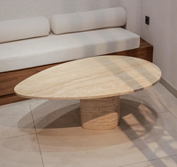 MEUBLES JIAMEIJIA |   Table basse en forme de galet effet travertin avec base sur piédestal