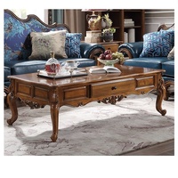 Table basse en bois antique de luxe avec pieds sculptés pour salon
