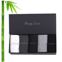 Vente en gros de chaussettes unies de luxe avec logo personnalisé Chaussettes lourdes tricotées décontractées antidérapantes pour les affaires Robe en bambou Couleurs blanches et noires