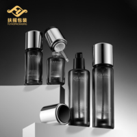 Ensemble de soins de la peau en verre noir fumé de luxe, flacon compte-gouttes vide pour tonique, lotion, sérum et pot à crème avec bouchon argenté, emballage