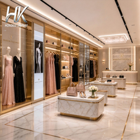 Présentoirs à vêtements écologiques personnalisés, étagères à sacs à main à cadre doré, présentoirs à chaussures, caissons lumineux LED pour affiches pour boutique de mode