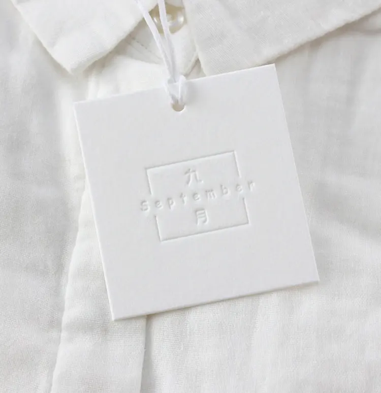 Custom Luxury Clothing Paper Swing Tag Labels Wholesale Embossed Label Hangtag