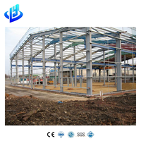 Almacén de estructura de acero de gran capacidad con vigas Q355B y muro cortina para almacenamiento de maquinaria pesada