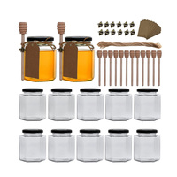 Pot en verre hexagonal miniature de 1,5 oz pour le miel avec un cuillère à miel en bois et des couvercles en métal doré