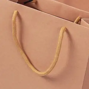 Keluaran baru tas kertas kraft dengan logo Anda lapisan matt pita pegangan merah muda cetak panas tas hadiah perunggu