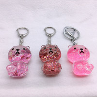 Nouveau design créatif mignon en gros porte-clés en acrylique liquide ours brun de dessin animé avec flotteur 3D OEM ODM disponible cadeau souvenir