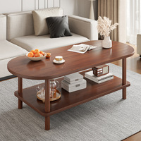 Table basse moderne minimaliste pour petits appartements et unités locatives ; pieds en bois massif, design discret, rangement à deux niveaux, forme ovale