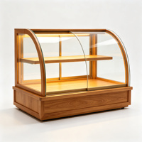 Vitrine à pain moderne haut de gamme multifonctionnelle en acrylique, avec cadre argenté et arche incurvée, éclairée par LED, pour boulangerie