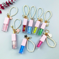 Nouveau design de soins rose dodu à base d'huile pour les lèvres filles fruits liquide brillant à lèvres baume à lèvres huile avec porte-clés
