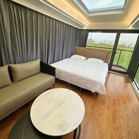 Maison capsule moderne de luxe en acier préfabriquée de 40 pieds, 1/2 chambre, mini-maison Apple, capsule spatiale solaire, salon, salle de bain pour usage hôtelier