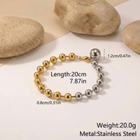 Bracelet minimaliste en acier inoxydable avec perles, orné d'un mélange de sphères polies or et argent et d'un fermoir mousqueton