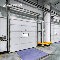 Puerta Seccional Industrial de Elevación Vertical, Paneles de Acero con Espuma de PU de 40 mm, Ventanas de Visión, Aislamiento Térmico, Operación Manual/Motorizada