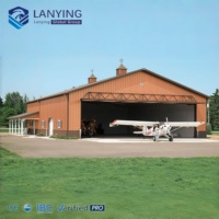 Hangar d'avion préfabriqué en structure métallique à grande portée avec portes coulissantes automatiques pour le stockage de jets privés