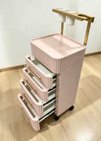 Chariot de rangement roulant de luxe moderne blanc crème avec poignées dorées et 4 roues robustes pour salon, salle de bain, hôtel, coiffure