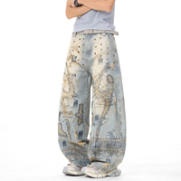 Jean vintage délavé coupe large avec broderie abstraite, œillets métalliques, effet usé et bords effilochés, style streetwear ample