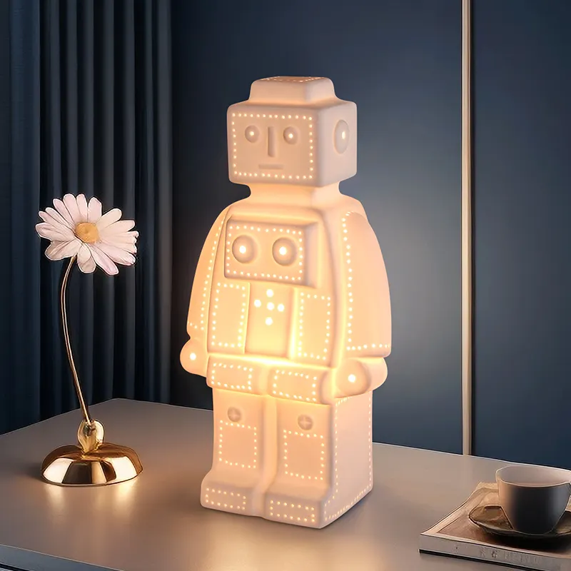 OEM/ODM Craft a buon mercato bianco lampada da tavolo in ceramica bambino luce notturna Led a forma di Robot lampada per soggiorno decorazione casa