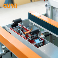 Machine d'emballage automatique GURKI pour la pose de fonds de cartons et la fermeture des boîtes, pour matériaux en papier, bois, vêtements, produits chimiques, certifiée CE