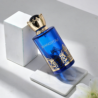Flacon de parfum en verre de luxe en gros avec bouchon doré orné d'une couronne, idéal pour l'emballage de parfums premium du Moyen-Orient de 100 ml