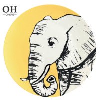 Service de table en porcelaine fine série animale, décor jaune mat, comprenant tasses et soucoupes, assiette de présentation en céramique motif éléphant